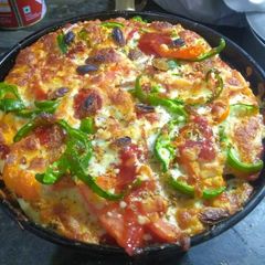 A picture of Capsicum onions tomato Pizza.