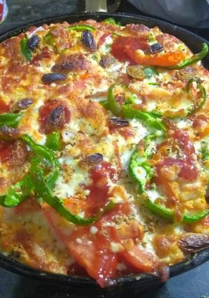 A picture of Capsicum onions tomato Pizza.