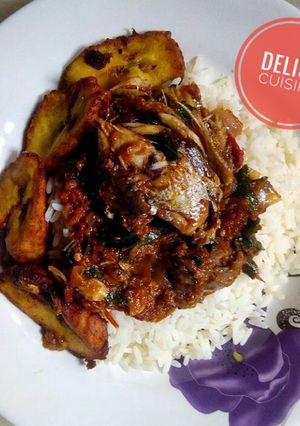 A picture of Rice and fish stew with plantain.