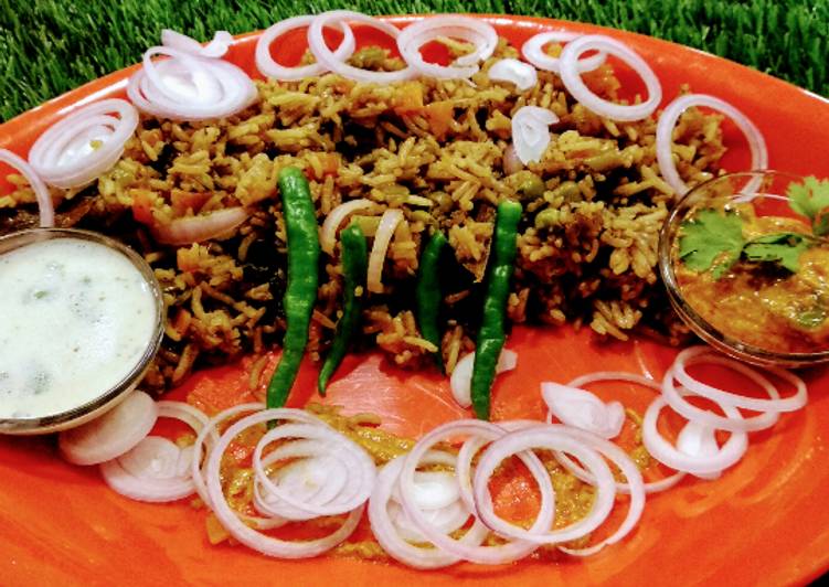 Hyderabadi biryani with mirch ka salan and garlic mint raita