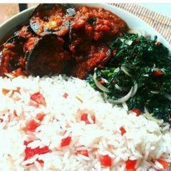 A picture of White rice with snail Stew and steamed spinach.