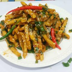A picture of Honey chilli potatoes with sesame seeds.