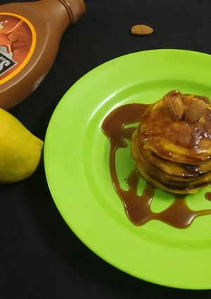 A picture of Mango Pancakes with Almonds and Caremal Sauce.
