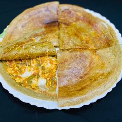 A picture of Stuffed green moong dal cheela with paneer burji & cheese.