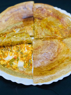 A picture of Stuffed green moong dal cheela with paneer burji & cheese.