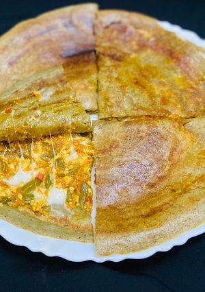 A picture of Stuffed green moong dal cheela with paneer burji & cheese.