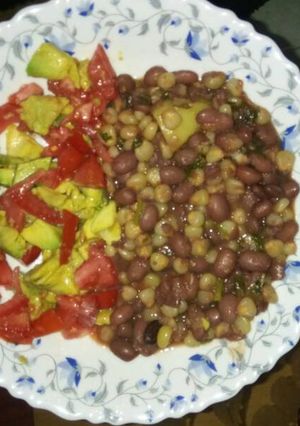 A picture of Githeri garnished with tomatoes and avocado.