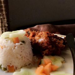 A picture of Coconut White Rice and chicken stew.