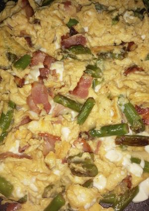 Una foto de Huevos revueltos con espárragos trigueros, bacon y queso