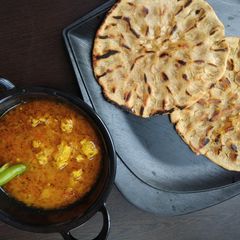 A picture of Khoba Roti with Gatta Curry.