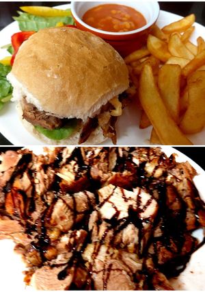 A picture of My Roast pork, Balsamic glaze on Crusty Cob with salad & chips.