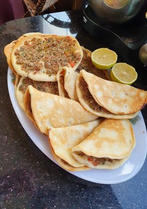A picture of Sfiha (Middle Eastern Meat Pies) with Vegetables.
