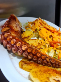 Una foto de Pulpo a la plancha con patatas panaderas y ensalada