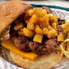 A picture of Grilled pork burger with curried apple chutney.