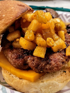 A picture of Grilled pork burger with curried apple chutney.
