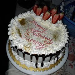 A picture of Redvelvet birthday cake with whipped cream frosting.