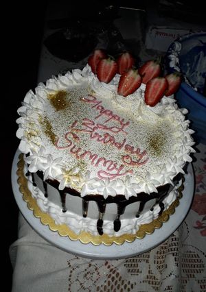 A picture of Redvelvet birthday cake with whipped cream frosting.