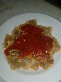 Una foto de Ravioles de jamón y queso con salsa