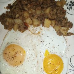 A picture of Aaloo Qeema with fried Eggs.