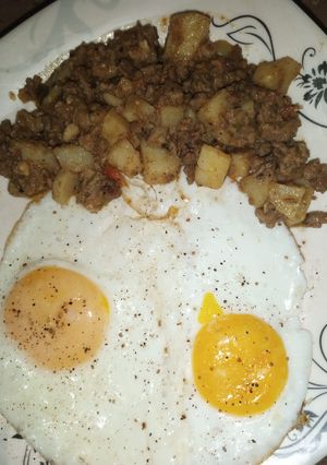 A picture of Aaloo Qeema with fried Eggs.