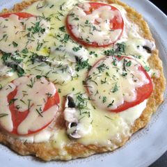 A picture of Potato Pancake covered with Melting Cheese.