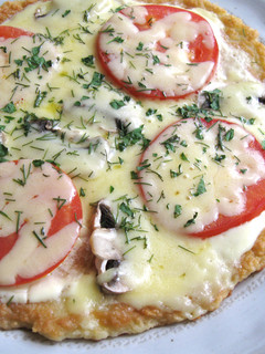 A picture of Potato Pancake covered with Melting Cheese.