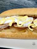 Bocadillo de solomillo y queso de cabra con cebolla caramelizada y salsa miel-mostaza