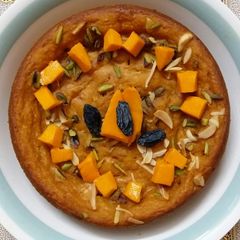 A picture of No maida Sponge cake topped with mango and dryfruit without oven.