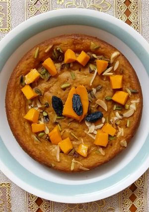 A picture of No maida Sponge cake topped with mango and dryfruit without oven.