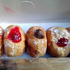 A picture of Homemade chocolate and strawberry jam doughnuts.