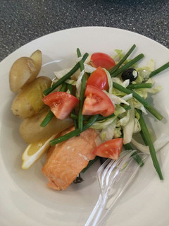 A picture of Salmon with boiled potatoes and fresh salad.