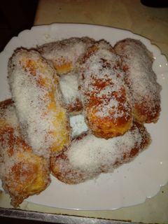 Una foto de Pan de leche relleno de crema de naranja cubierto de coco rallado