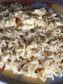 A picture of Noodles and fried egg.