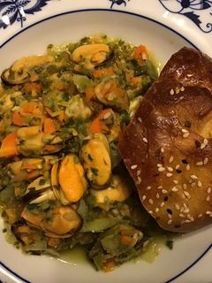 A picture of California Farm Steamed Mussels with Rouille and Rolls.