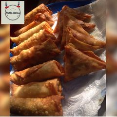A picture of Samosa and spring rolls home made pastries.