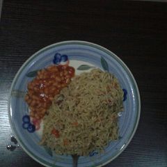 A picture of Spicy noodles with sardine and baked beans.