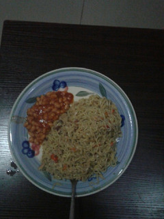 A picture of Spicy noodles with sardine and baked beans.