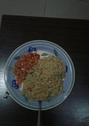 A picture of Spicy noodles with sardine and baked beans.