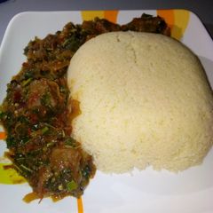A picture of Cous cous with spinach soup.