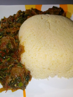 A picture of Cous cous with spinach soup.