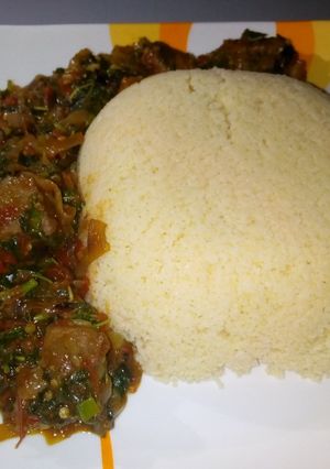 A picture of Cous cous with spinach soup.