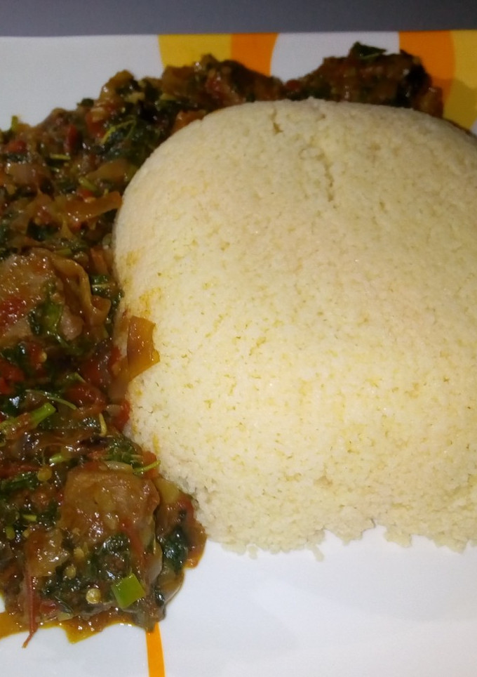 A picture of Cous cous with spinach soup.