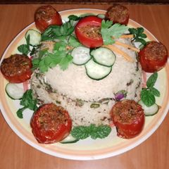 A picture of Stuffed tomatoes 🍅 with Arusha rice 🍚🧄🧅.