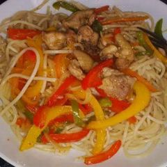 A picture of Spaghetti with veggies chicken stir fry.