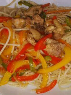 A picture of Spaghetti with veggies chicken stir fry.