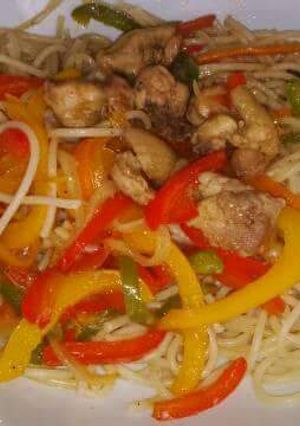 A picture of Spaghetti with veggies chicken stir fry.