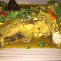 A picture of Fish peepered soup garnish with parsely.