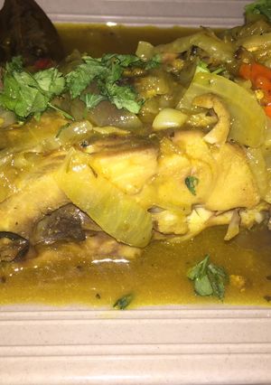 A picture of Fish peepered soup garnish with parsely.