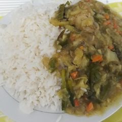 A picture of White rice with chicken sauce.