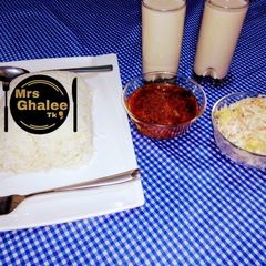 A picture of White and rice with coleslow and tigernut drink.
